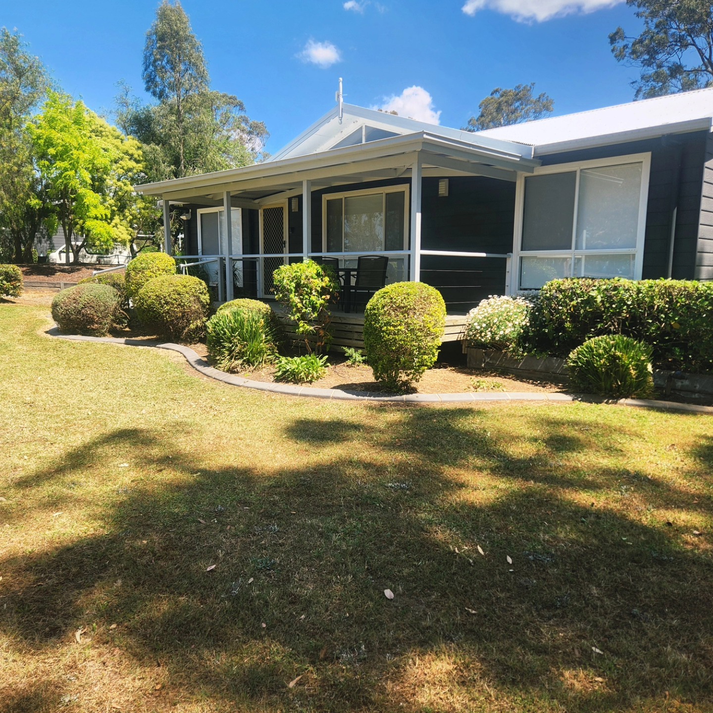 Rural homestead with round-trimmed shrubs — Hills District