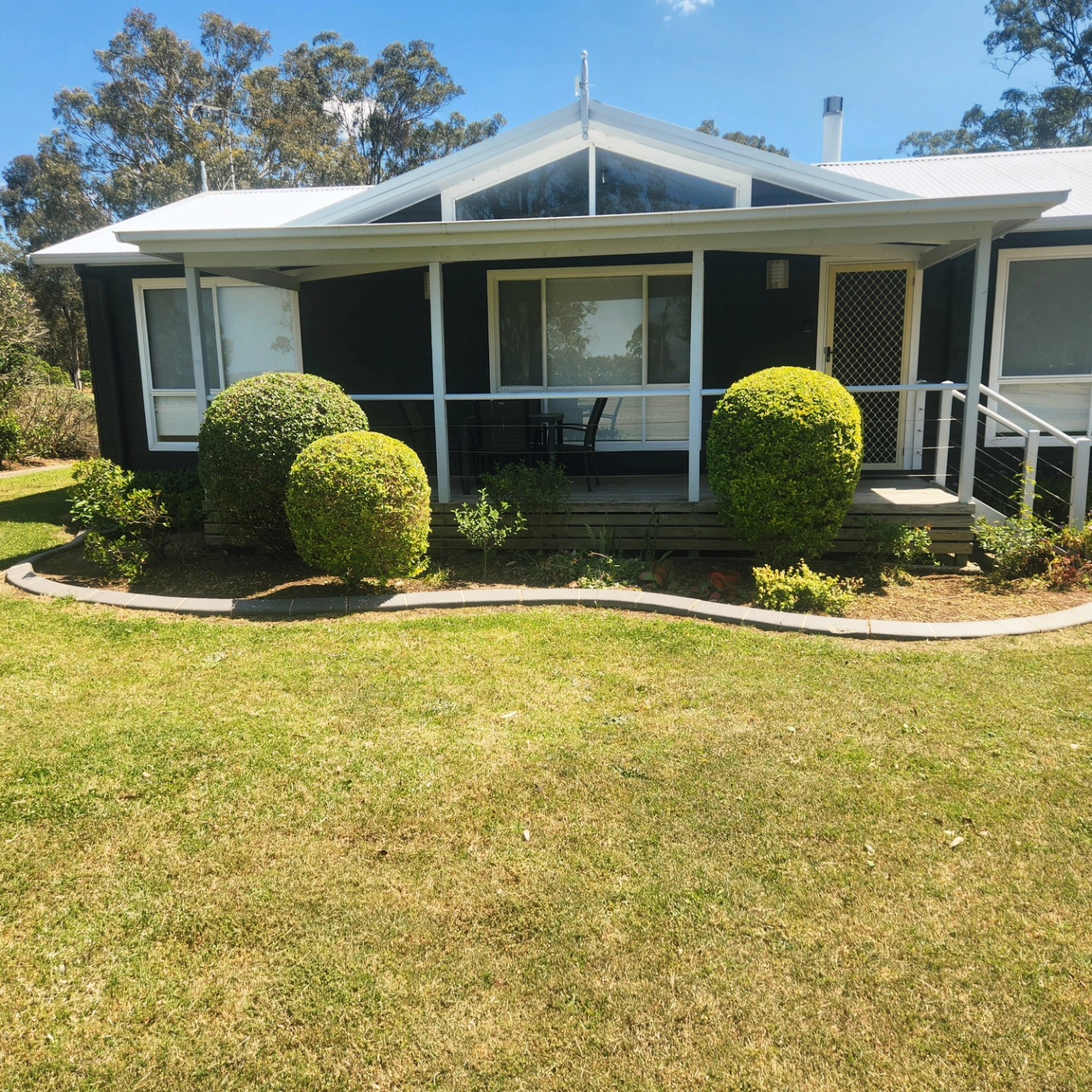 Sphere topiary beside a Hills District farmhouse verandah