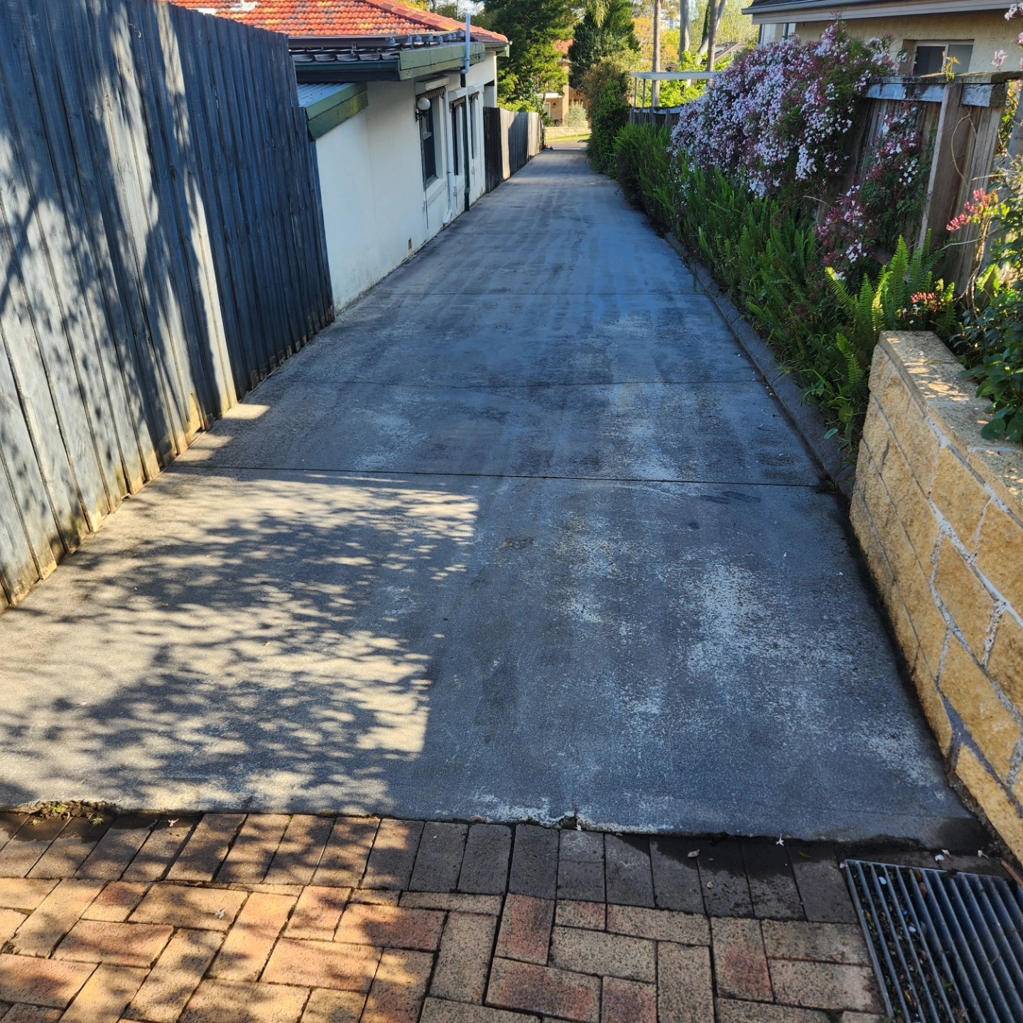 Clean brick courtyard with neatly trimmed hedge — Sydney