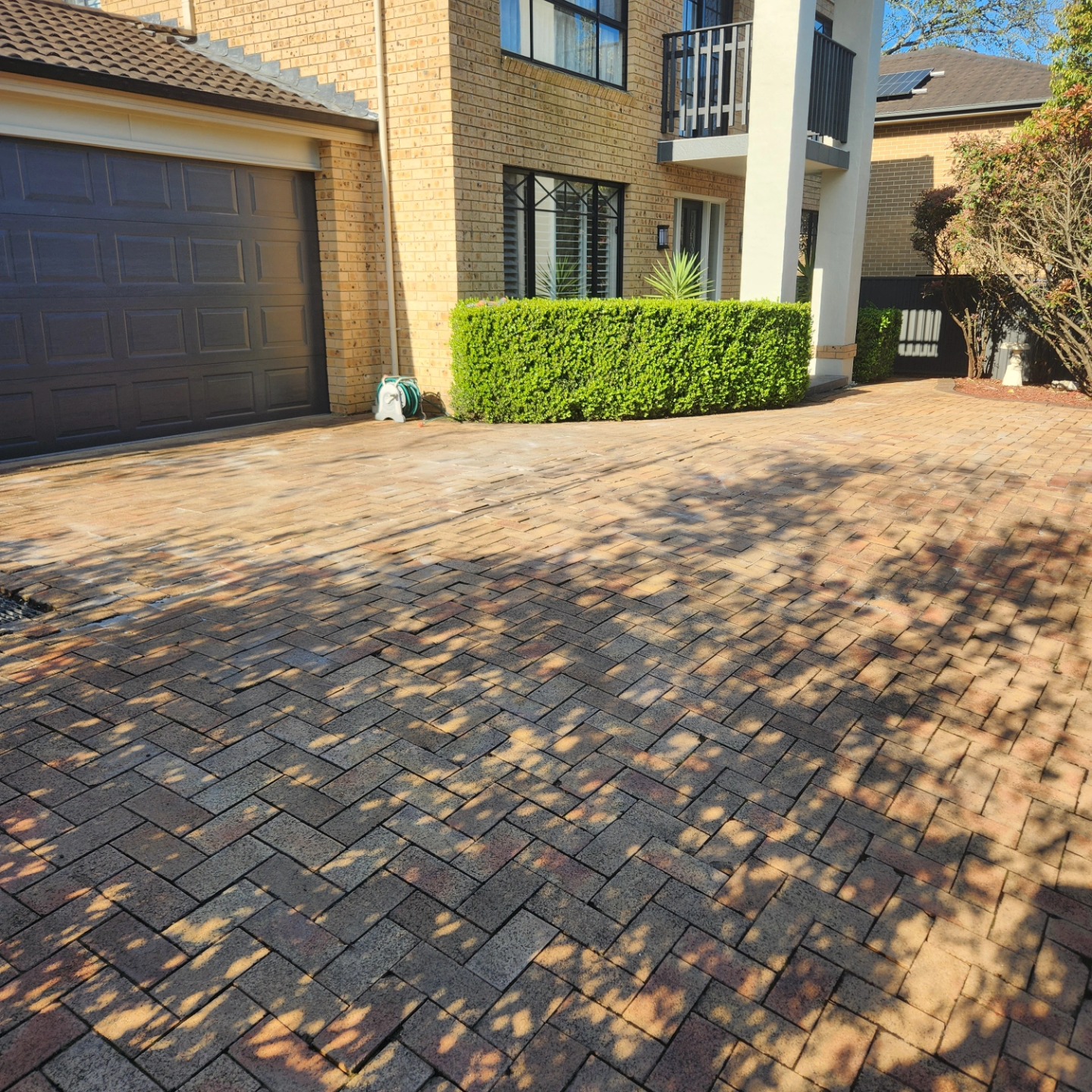 Pressure washing a brick driveway — Benji's Gardens Sydney